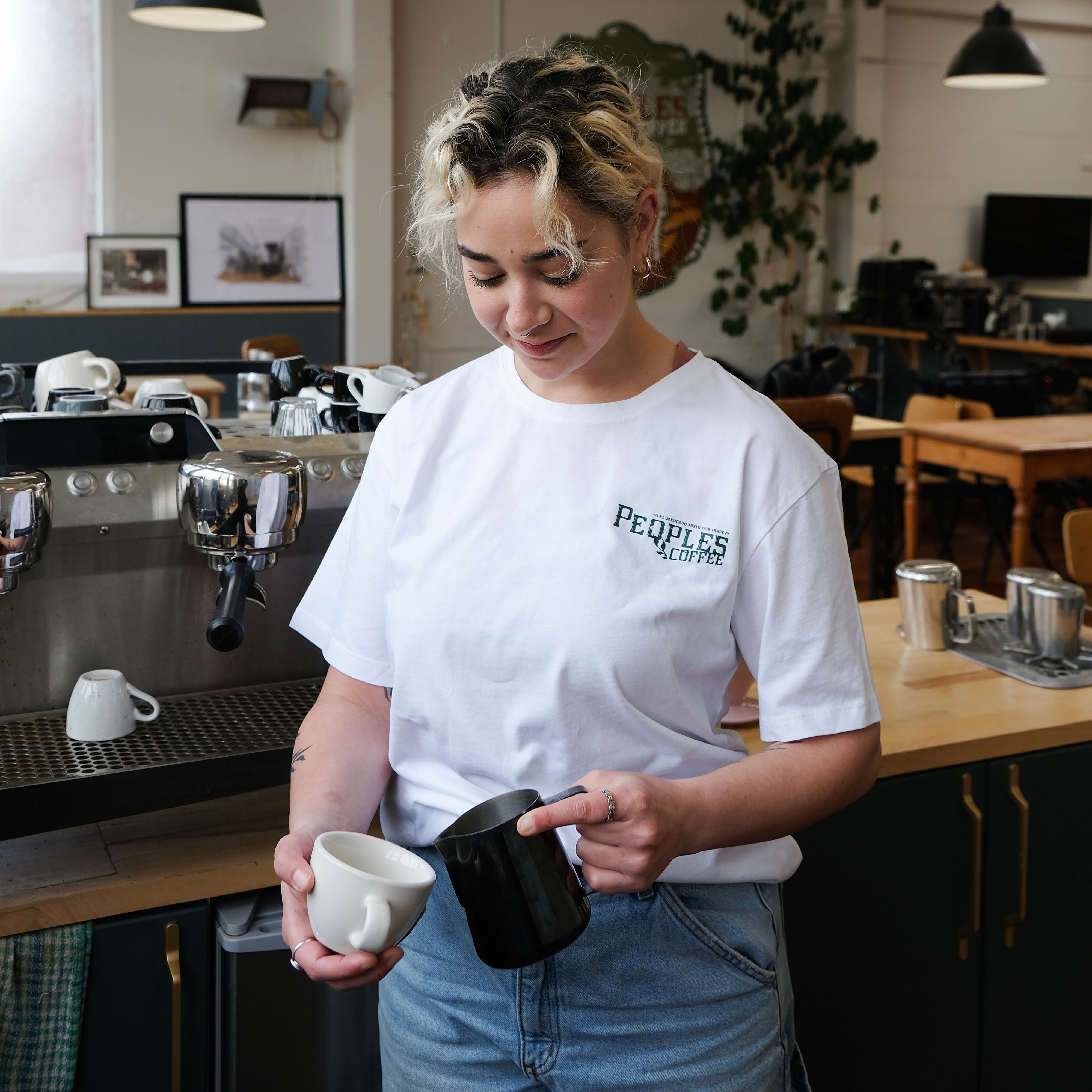 white t-shirt from the front on woman in a cafe