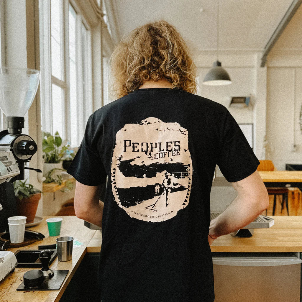 man wearing black shirt with peoples coffee logo from behind